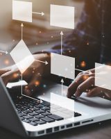 Group fairness - iStock-1360521207 Person using computer with virtual chart floating on top