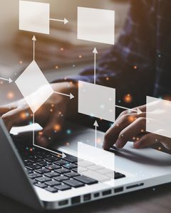 Person using computer with virtual chart floating on top